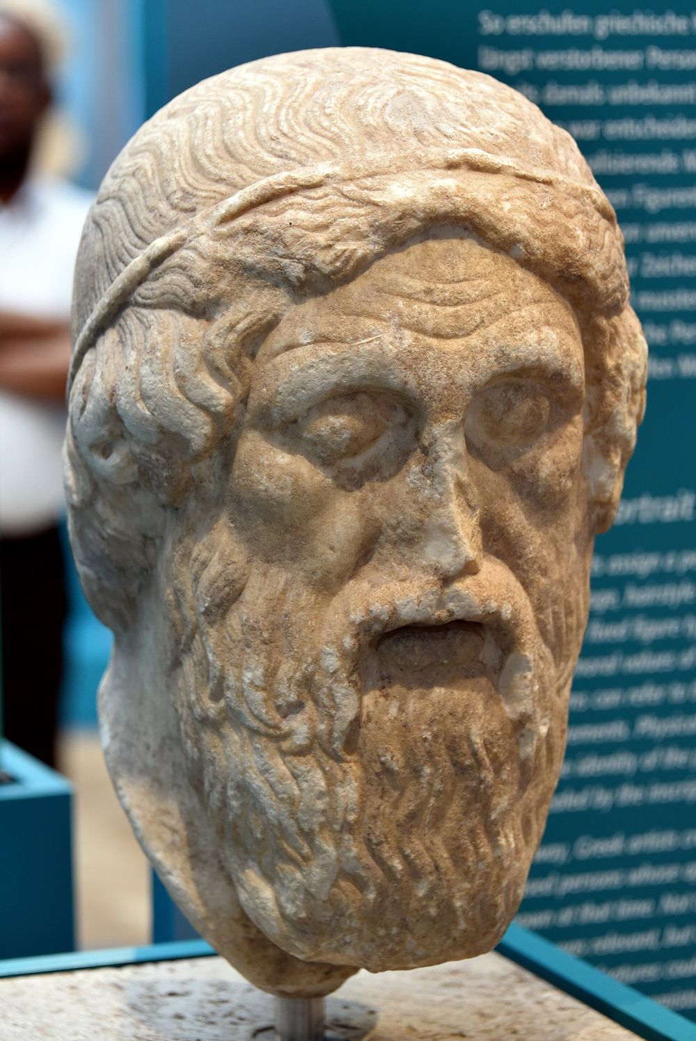 Ancient Greek marble bust of Homer against a neutral stone background
