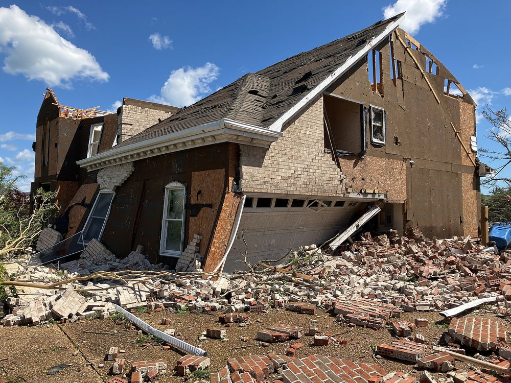 A residential neighbourhood showing structural wind damage to roofs and walls following a severe weather event