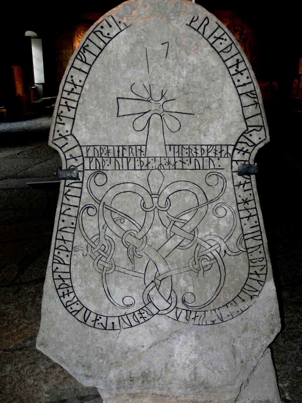 Carved Scandinavian runestone standing outdoors in Gotland under natural daylight