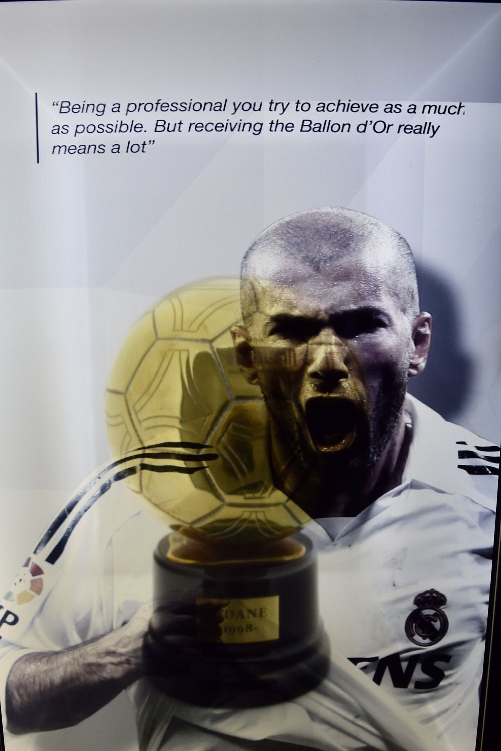 The Ballon d'Or golden football trophy displayed on a stand at an awards ceremony