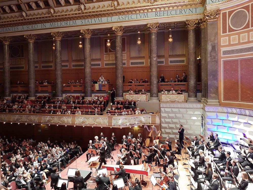 Violinist Aleksey Semenenko coming to receive applause after performing in concert with the Kyiv Syphony Orchestra at Kurhaus Wiesbaden, conducted by Luigi Gaggero who stands at…